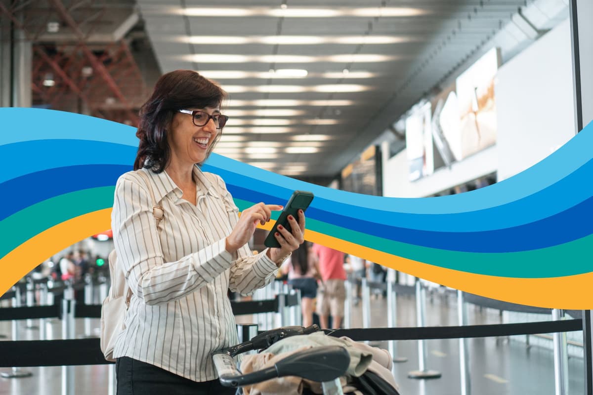 a woman is using a cell phone at an airport .