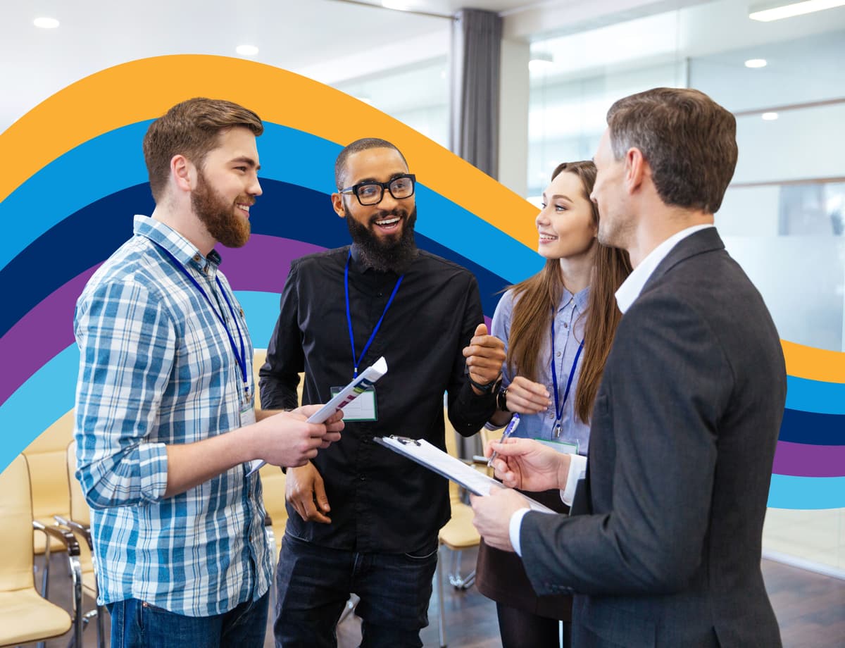 a group of people are standing in a room talking to each other .