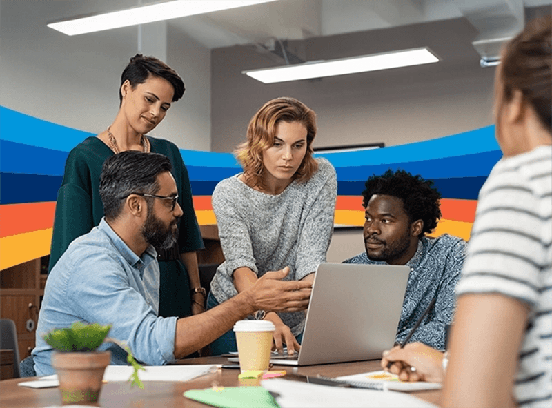 a group of people are looking at a laptop computer
